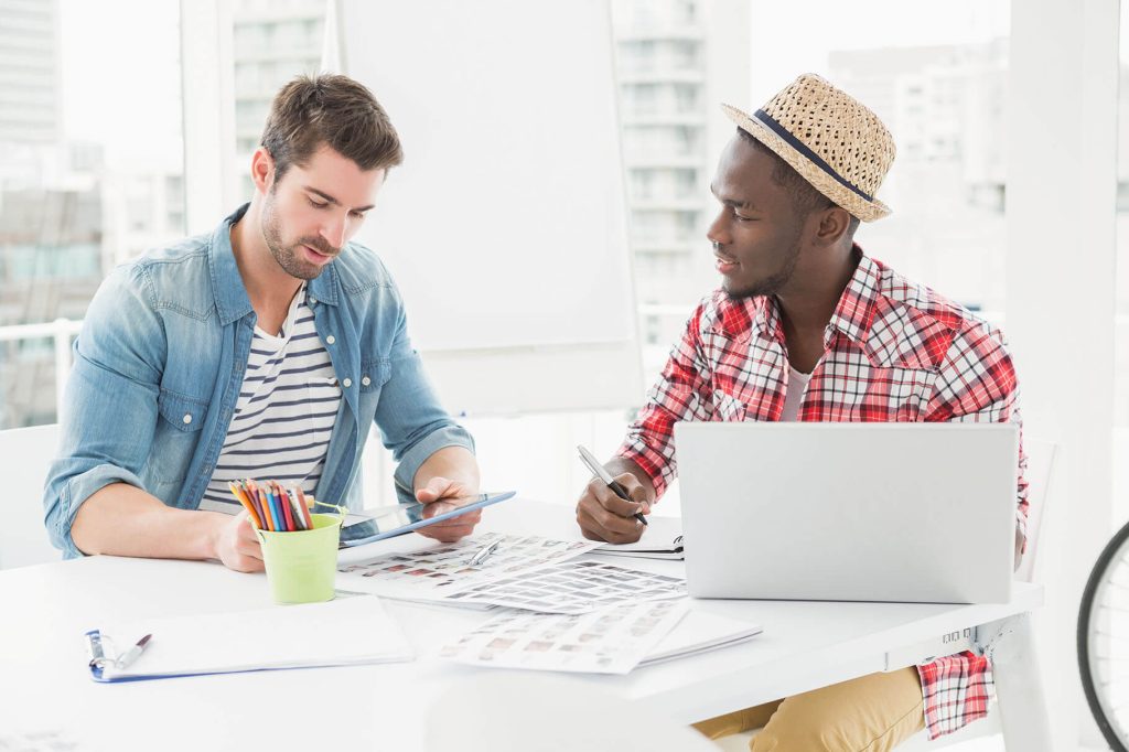 colleagues sitting using tablet and laptop in the PN5TXYP